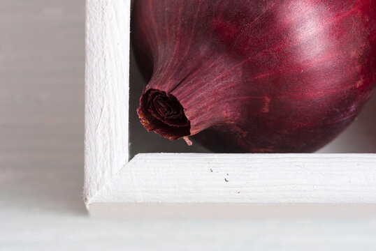 onions on white wood tray, wooden table background