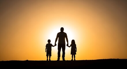 Fototapeta premium Family silhouette at sunset a father and two children holding hands
