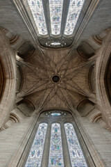 Looking upward into the Under Tower vaulting interior of Liverpool Cathedral, the central tower intricate vaulting blooms like a celestial flower. Delicate stone ribs radiate from a central boss, weav