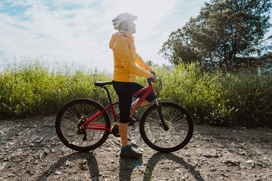 Senior woman enjoying mountain bike ride in nature