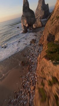 FPV drone at Praia da Ursa in Portugal with dramatic cliffs and ocean at sunset.
4K high quality cinematic scenic footage.