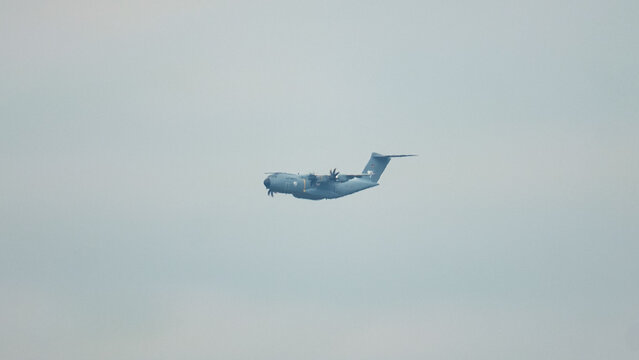 Powerful Airbus A400M Atlas in flight for strategic airlift and aerial refueling missions over a cloudy sky at dawn