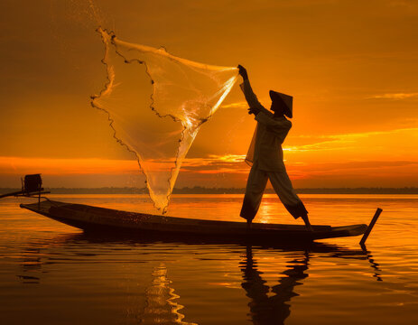 Fisherman at Sunset: Silhouette of a fisherman casting a fishing net from a boat on a tranquil lake, bathed in the warm, golden hues of the setting sun.