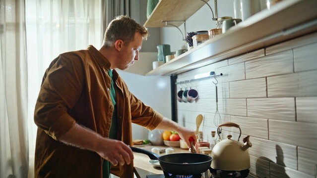 Man salting tasty dish in frying pan cooking nutritious food kitchen closeup.
