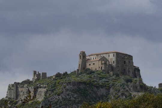 An ancient fortress and monastery on a hilltop.The majestic stone castle of Roccella. Italy, April 10, 2026