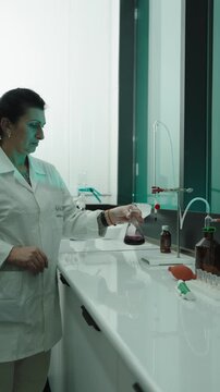 Winery, wine production. Quality control. winemakers laboratory testing wine in winery lab. Measurement alcohol content cold stability density malic acid red grape color sugar sulfur dioxide 