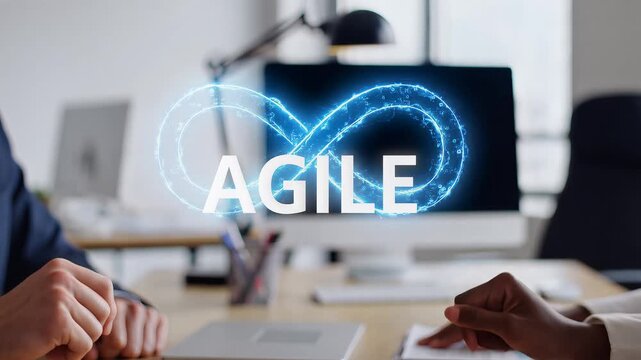 Agile methodology concept visualized with an infinity loop symbol and the word Agile on a computer screen in an office setting.