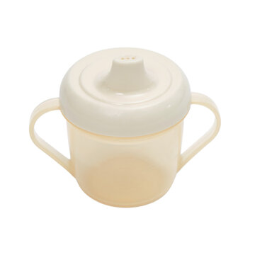 Plastic baby sippy cup with two handles isolated on transparent background. Empty toddler drinking bottle for liquid feeding. Child development and infant kitchenware accessory product shot.