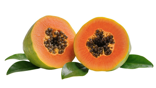 Halved orange papaya with seeds and green leaves