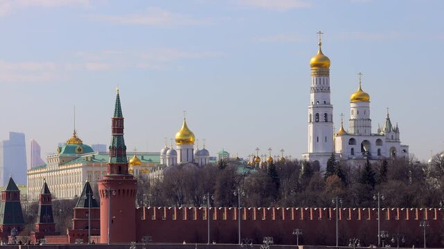 A picturesque view of the Kremlin featuring its iconic golden domes and towers against a vibrant sky, epitomising the historical and architectural grandeur of Russia.