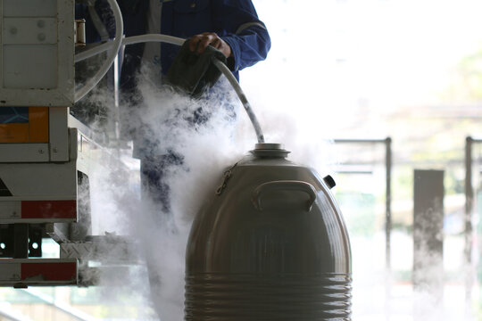 Liquid nitrogen is being transferred from container, creating dramatic cloud of vapor. scene fascinating process of handling cryogenic