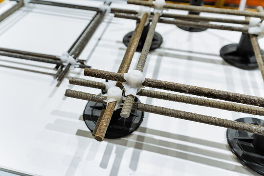 Reinforcement Setup Prepared. Rebar Grid Installed With Supports. Structural Reinforcement Ready For Concrete Pouring. Steel Reinforcement With Spacers Installed For Construction Process