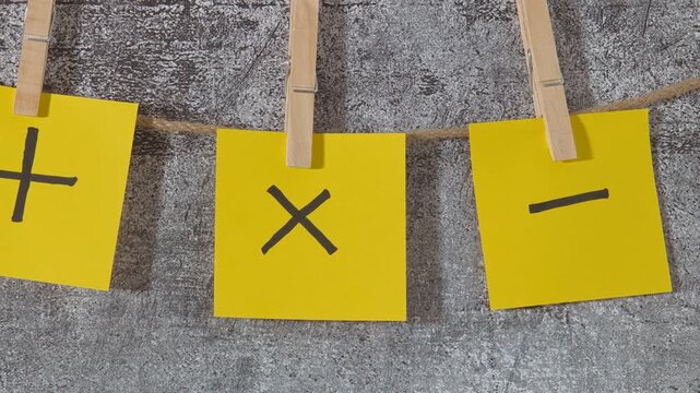 yellow sticky notes with plus and minus signs