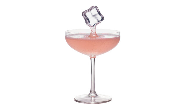 Clear ice cube splashing into pink cocktail in coupe glass, isolated on transparent background