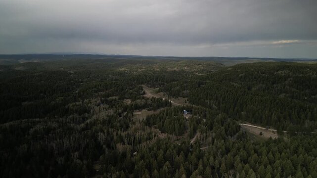 Aerial of Sunspot Highway south of Cloudcroft New Mexico on stormy spring day