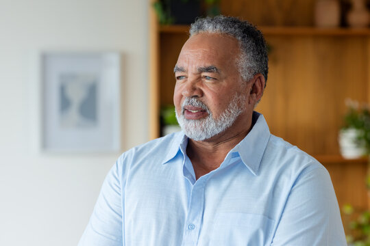Senior African American man looking right in home-office shelves pots framed print light-blue shirt