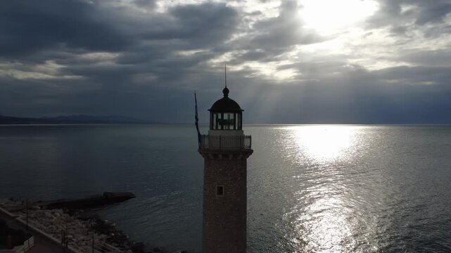 Close up shot of a traditional lighthouse on a pier during a golden sunset