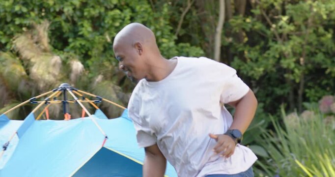 Adult running toward tent, youth chasing around blue tent, animated motion lines for health