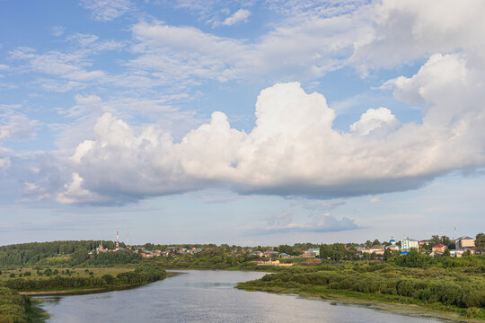 Scenic river landscape with majestic clouds in sky in Sovetsk, Kirov region, Russia