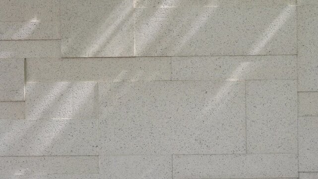 Concrete wall texture with sunlight shadow minimal background