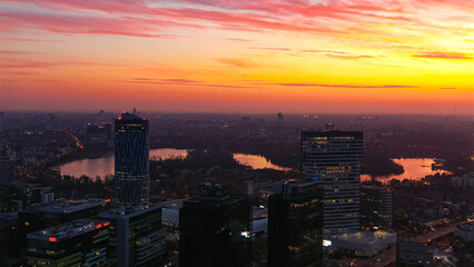 Fototapeta premium Bucharest aerial view skyscraper lake sunset vibrant sky