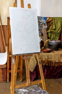 An easel with a still life sketch in an art studio. Drawing from life in a classroom. 