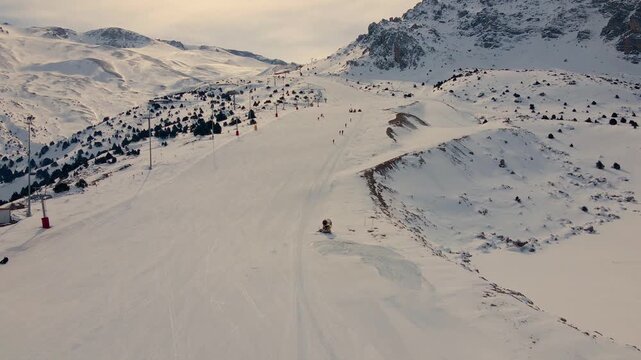 Skiers glide down wide, groomed trail. Ergan Mountain Erzincan Turkey