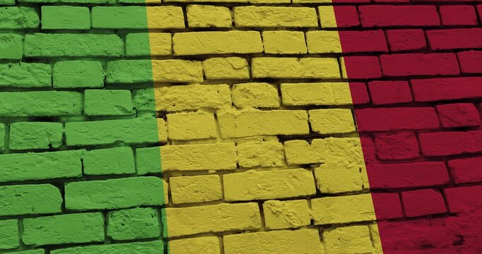 A panning video of a brick wall with the mali flag