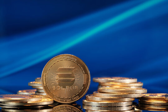 Solana Cryptocurrency Coins Stacked Together on a Blue Background