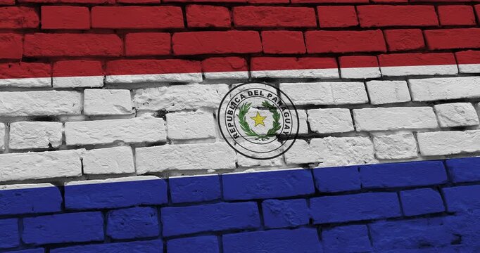 A panning video of a brick wall with the paraguay flag