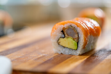 Salmon maki sushi roll with avocado and tempura shrimp © Guillermo Spelucin