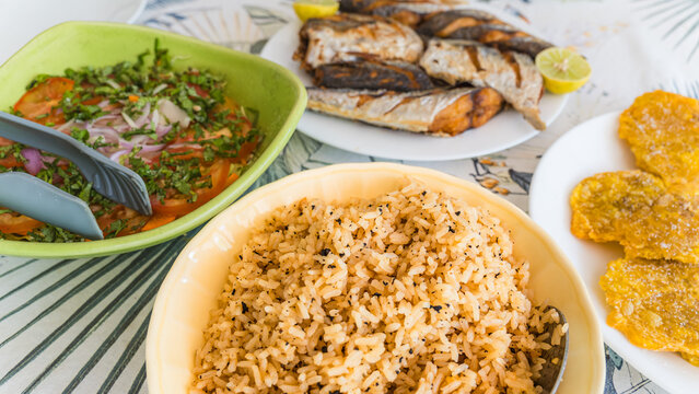Caribbean feast with rice, salad, fish, and plantains