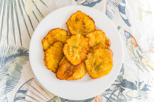 Fried plantain slices on a tropical table setting