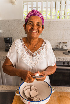 Caribbean woman preparing tropical coconut dish