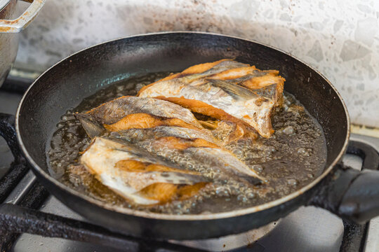 Caribbean fried fish in sizzling skillet