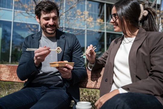 Business colleagues sharing lunch and ideas outdoors