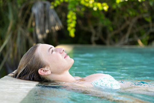 teenage girl relaxing in a pool, Vilankulos, Mozambique, Africa