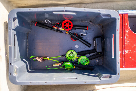 Fishing gear in plastic tub with rods and reels in Finland