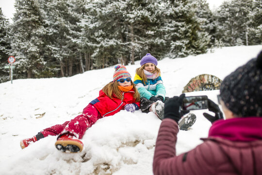 Family enjoying snowy day with playful children
