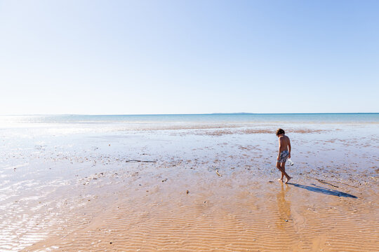 young boy exploring coastline, Vilankulos, Mozambique, Africa