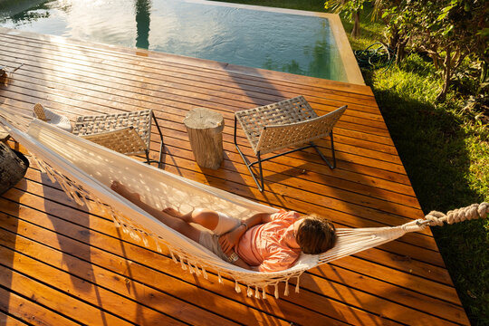10 year old boy relaxing in hammock, Vilankulos, Mozambique, Africa