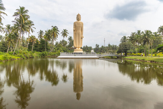 Peraliya, Sri Lanka - January 7, 2026: Tsunami Honganji Vihara, a solemn and towering standing Buddha statue, memorial for the victims of the tsunami natural disaster.