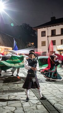Scottish Highland Dancers Perform Traditional Dance Outdoors at Night.