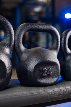 8 kg kettlebell on gym bench with multiple weights and blurred fitness background
