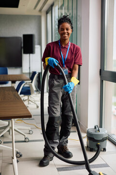 Portrait of happy black facilities maintenance professional looking at camera