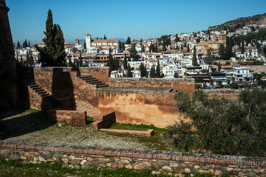 Alhambra fortress walls overlooking albaic&iacute;n cityscape and historic granada architecture in spain