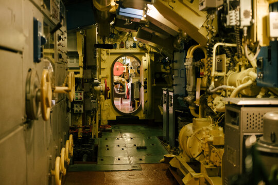 Submarine, interior and machinery with pipes, controls and equipment for navigation, exploration and underwater operations. Industrial, technology and engineering environment with metal surfaces.