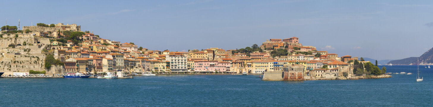 View of the sun kisses the terracotta rooftops of Portoferraio, as boats bob gently on the turquoise waters, painting a vivid tableau of coastal charm, Portoferraio, Elba, Tuscany, Italy.