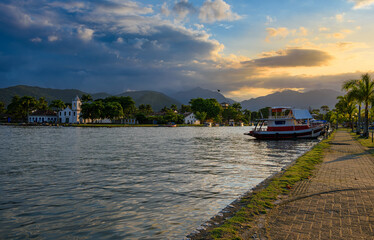 Embankment of historical center with boats in Paraty at sunset, Rio de Janeiro, Brazil. Paraty is a preserved Portuguese colonial and Brazilian Imperial municipality