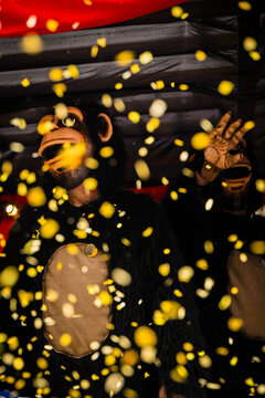 Basel, Switzerland - 10 March 2025: View of a costumed reveler amidst a flurry of confetti, embodying the vibrant chaos of Fasnacht.